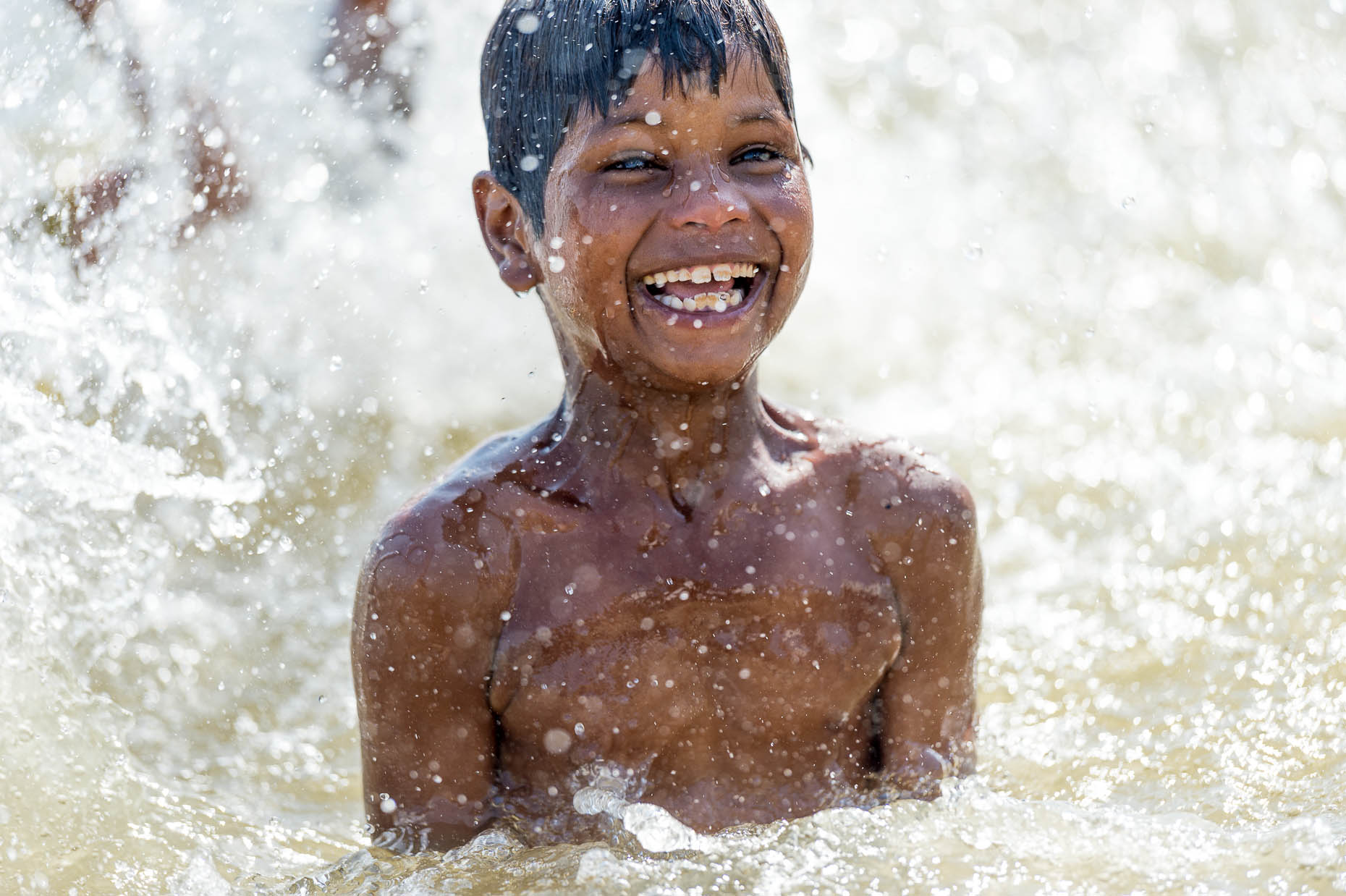 Boy-playing-in-water-India