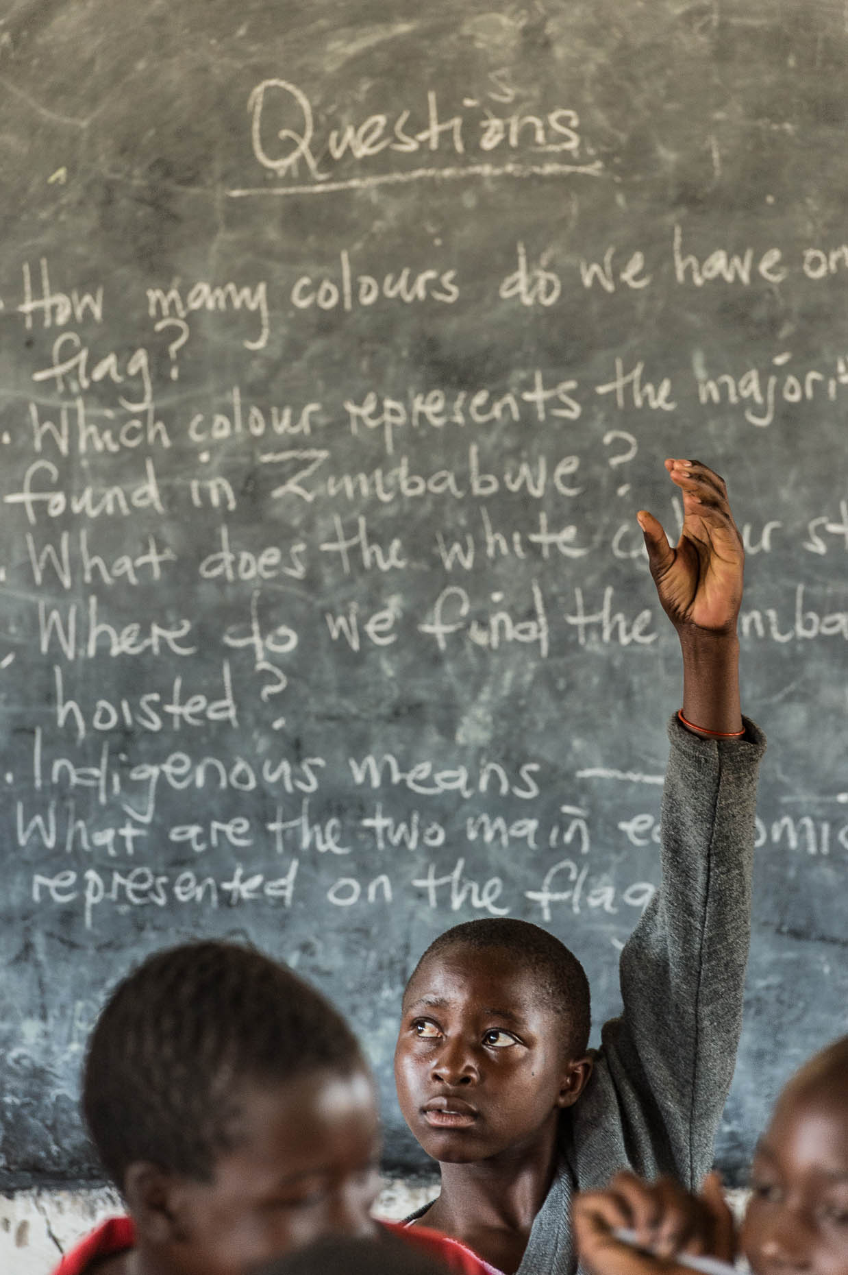 Female-raises-hand-in-classroom-Zimbabwe