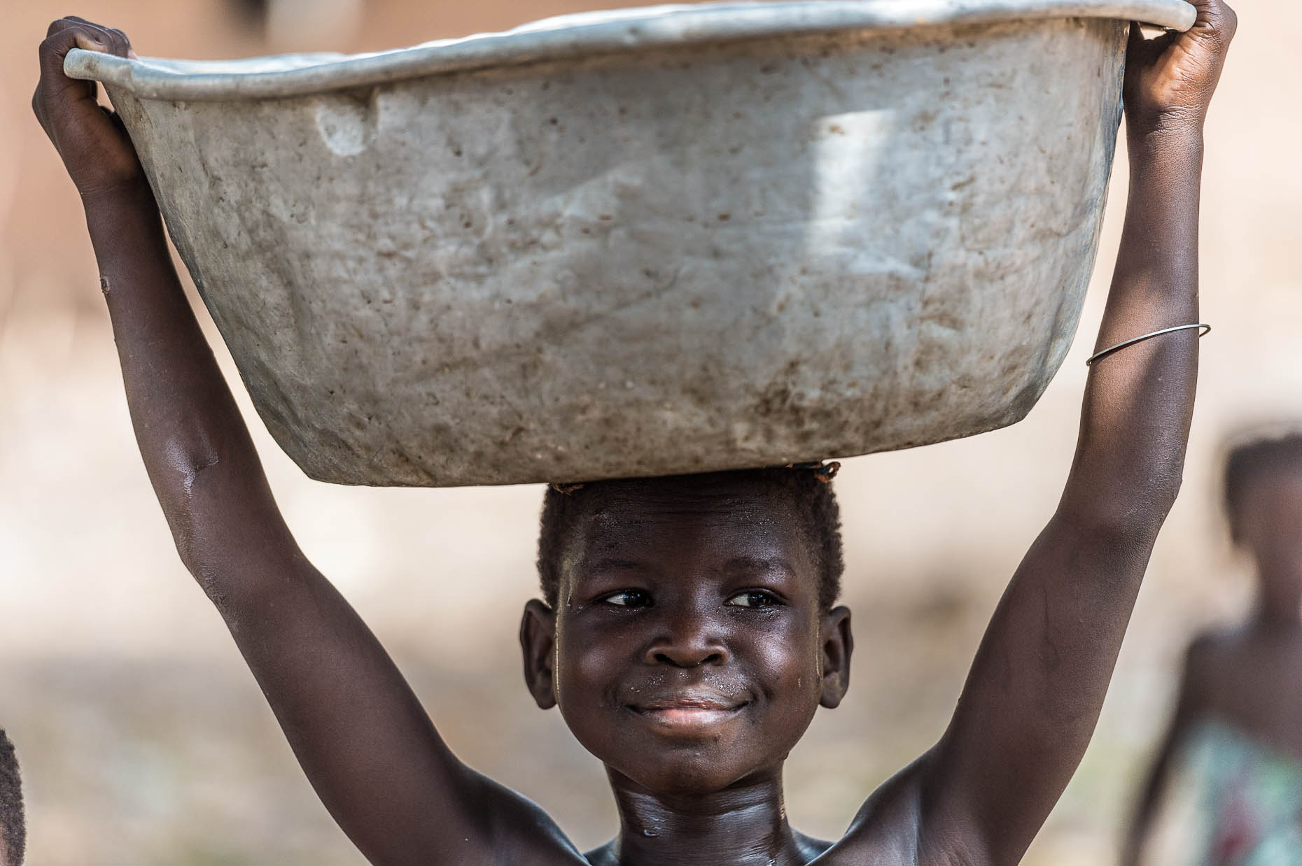 Girl-with-water-container-on-head-Ghana