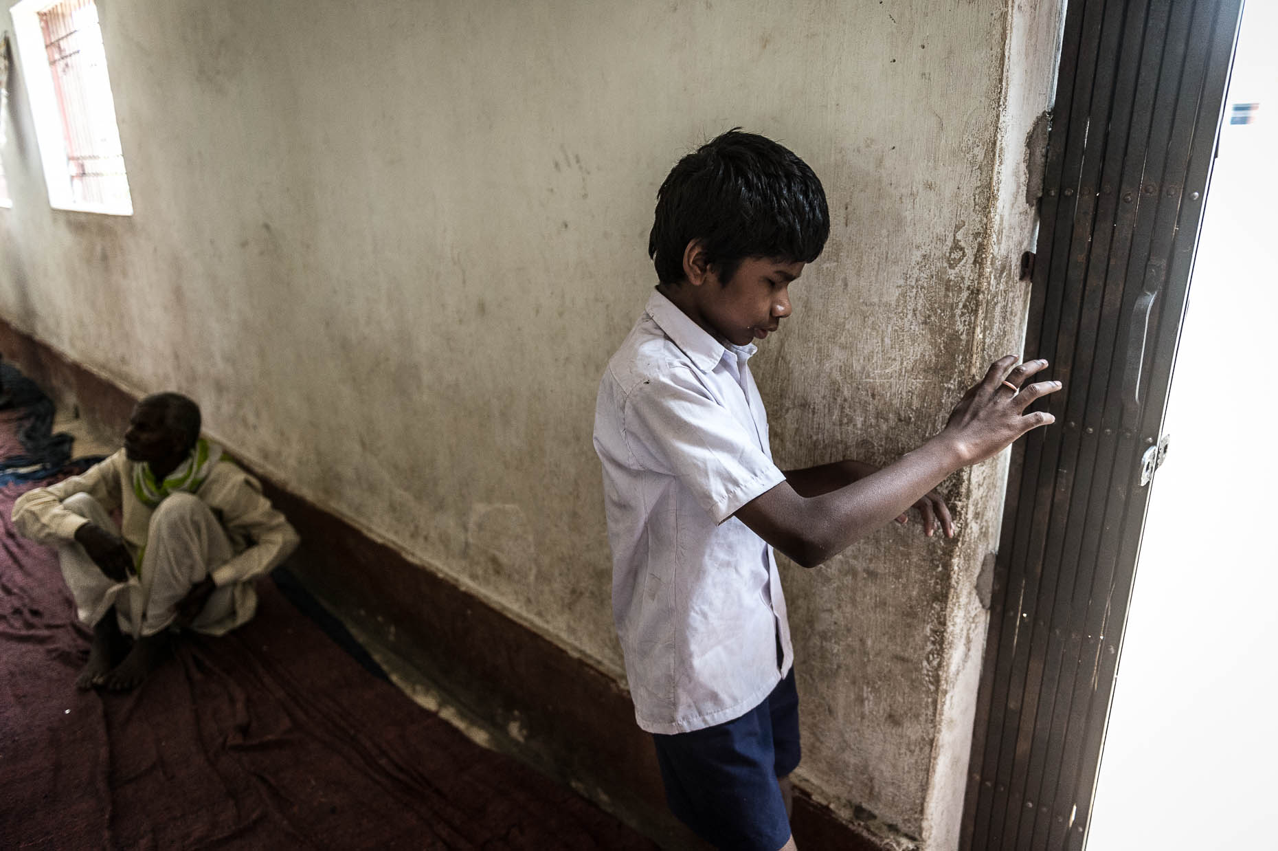 Blind-orphan-walking-along-wall-India
